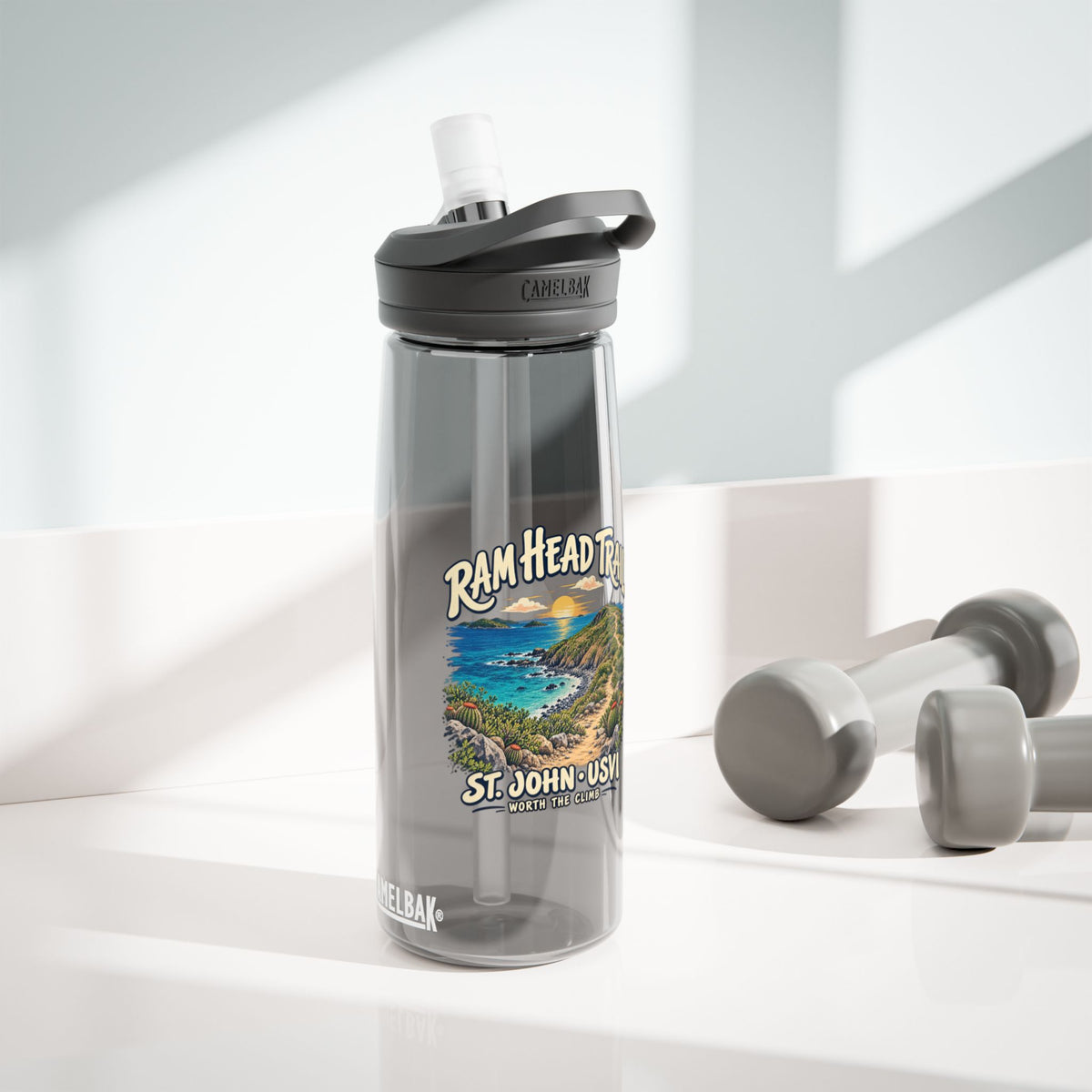 Charcoal CamelBak Eddy 25 oz bottle with Ram Head Trail St John USVI artwork in a lifestyle setting.