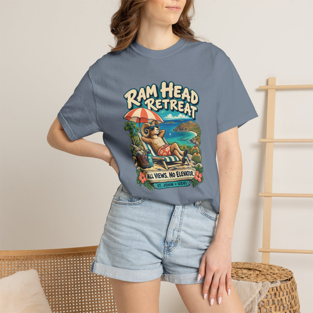 Model wearing a Comfort Colors 1717 T-shirt with the Ram Head Retreat lounging ram illustration and St. John USVI lettering.