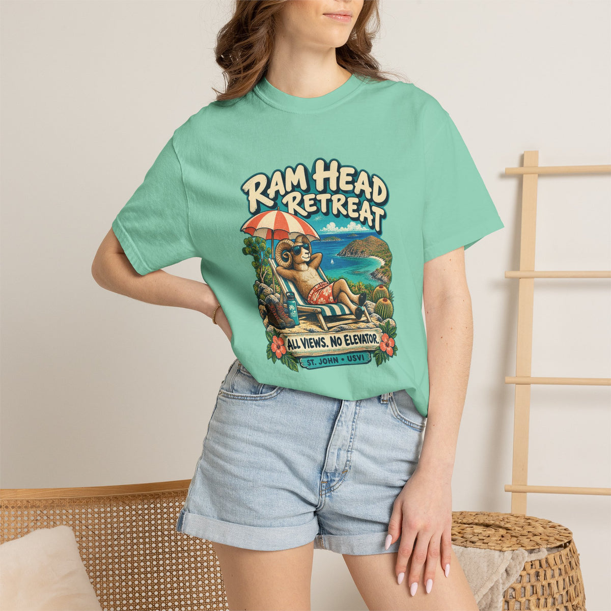 Model wearing a Comfort Colors 1717 T-shirt with the Ram Head Retreat lounging ram illustration and St. John USVI lettering.
