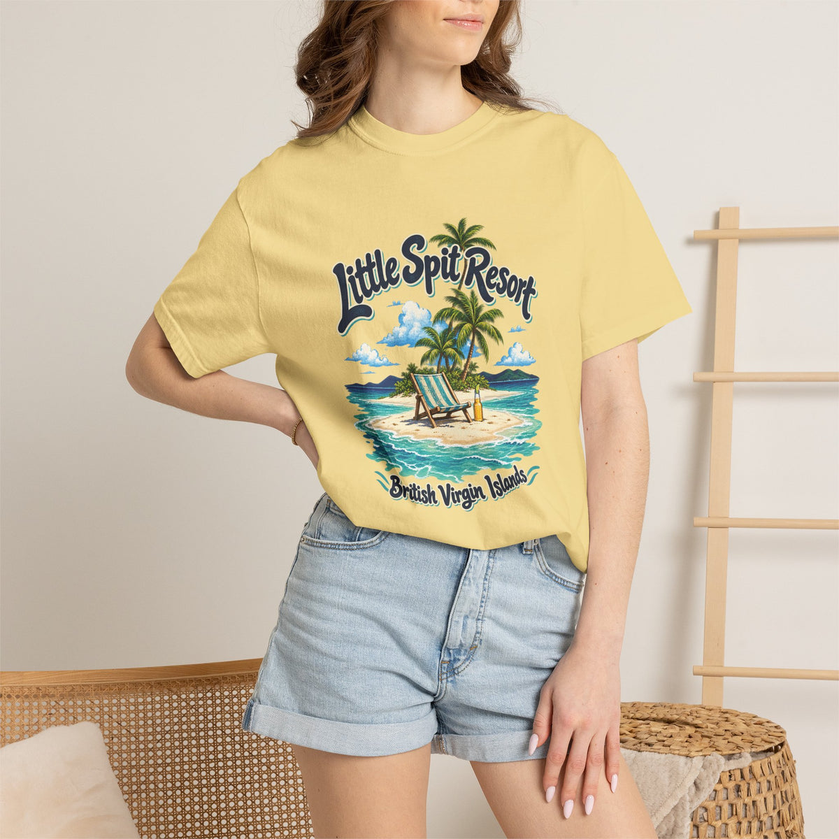 Model wearing the Little Spit Resort BVI Comfort Colors 1717 T-shirt with a playful beach-chair, palm-tree, and bottle illustration.