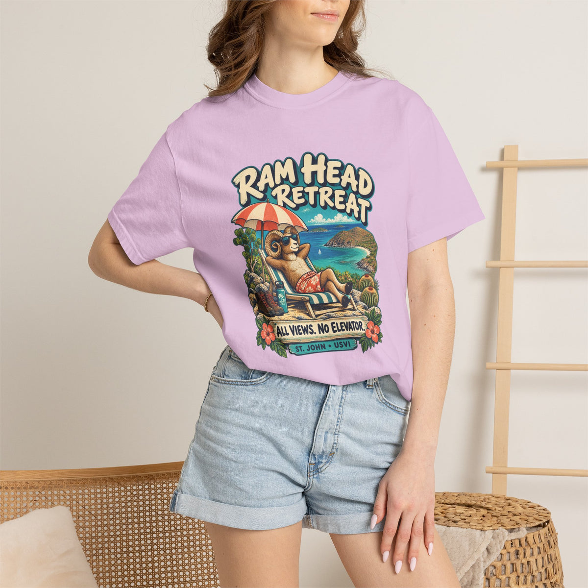 Model wearing a Comfort Colors 1717 T-shirt with the Ram Head Retreat lounging ram illustration and St. John USVI lettering.