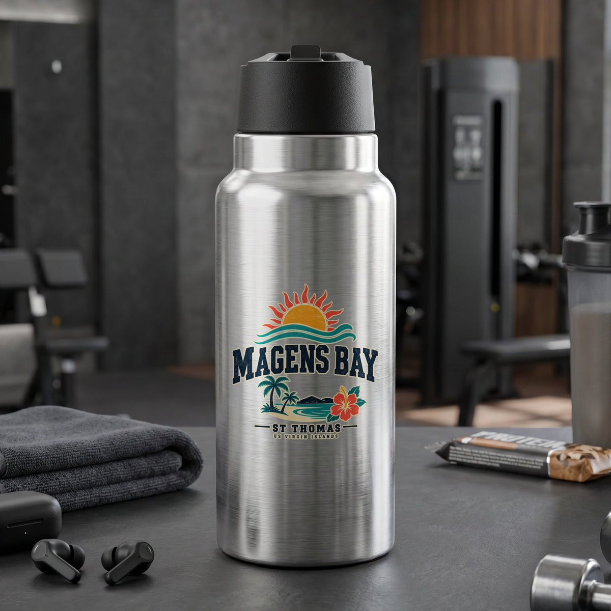 Silver water bottle with Magens Bay St. Thomas logo in a gym setting