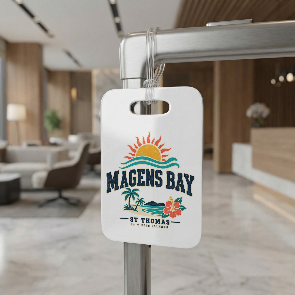 White luggage tag with Magens Bay St. Thomas graphic, featuring a sunset, waves, palm trees, and hibiscus flower.