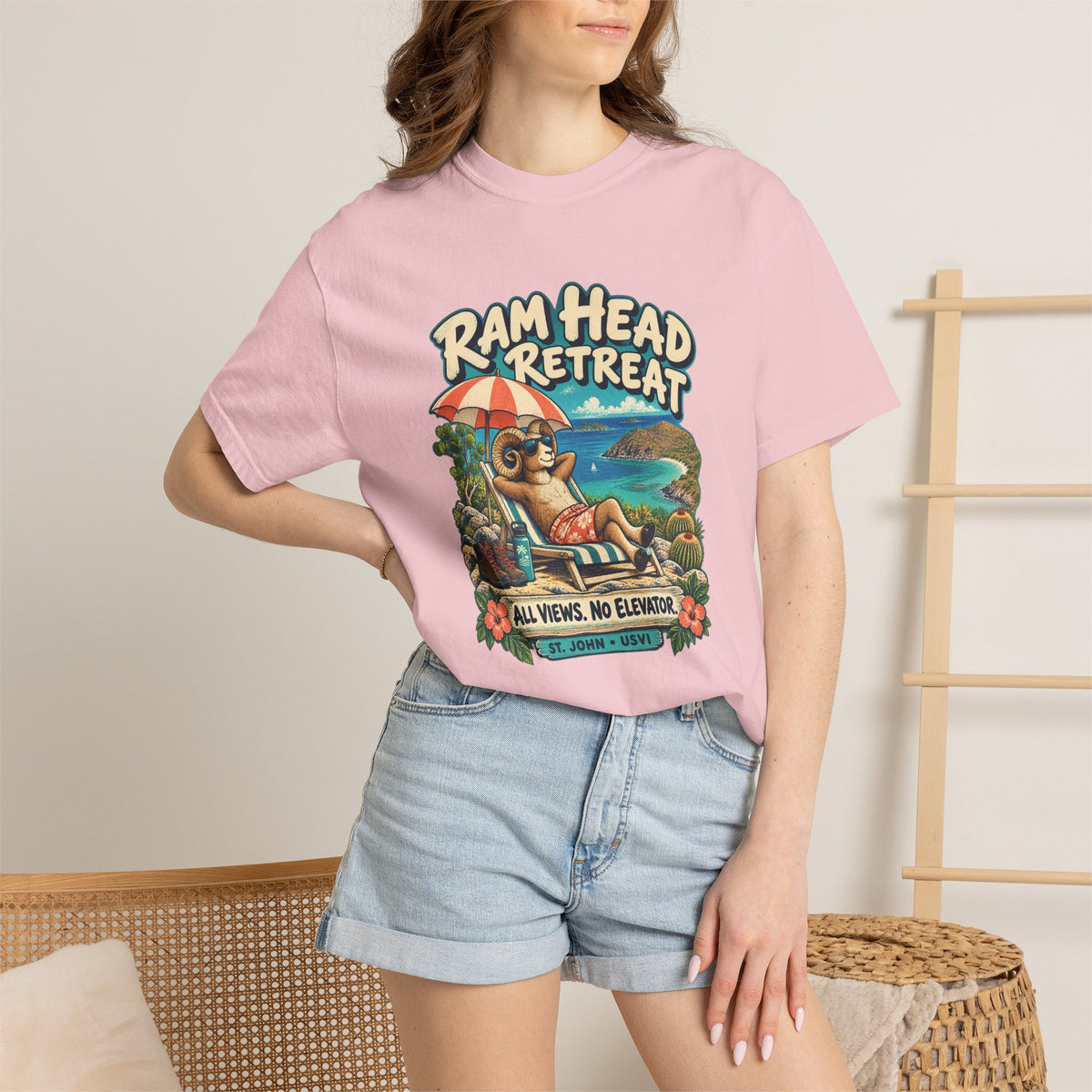 Model wearing a Comfort Colors 1717 T-shirt with the Ram Head Retreat lounging ram illustration and St. John USVI lettering.