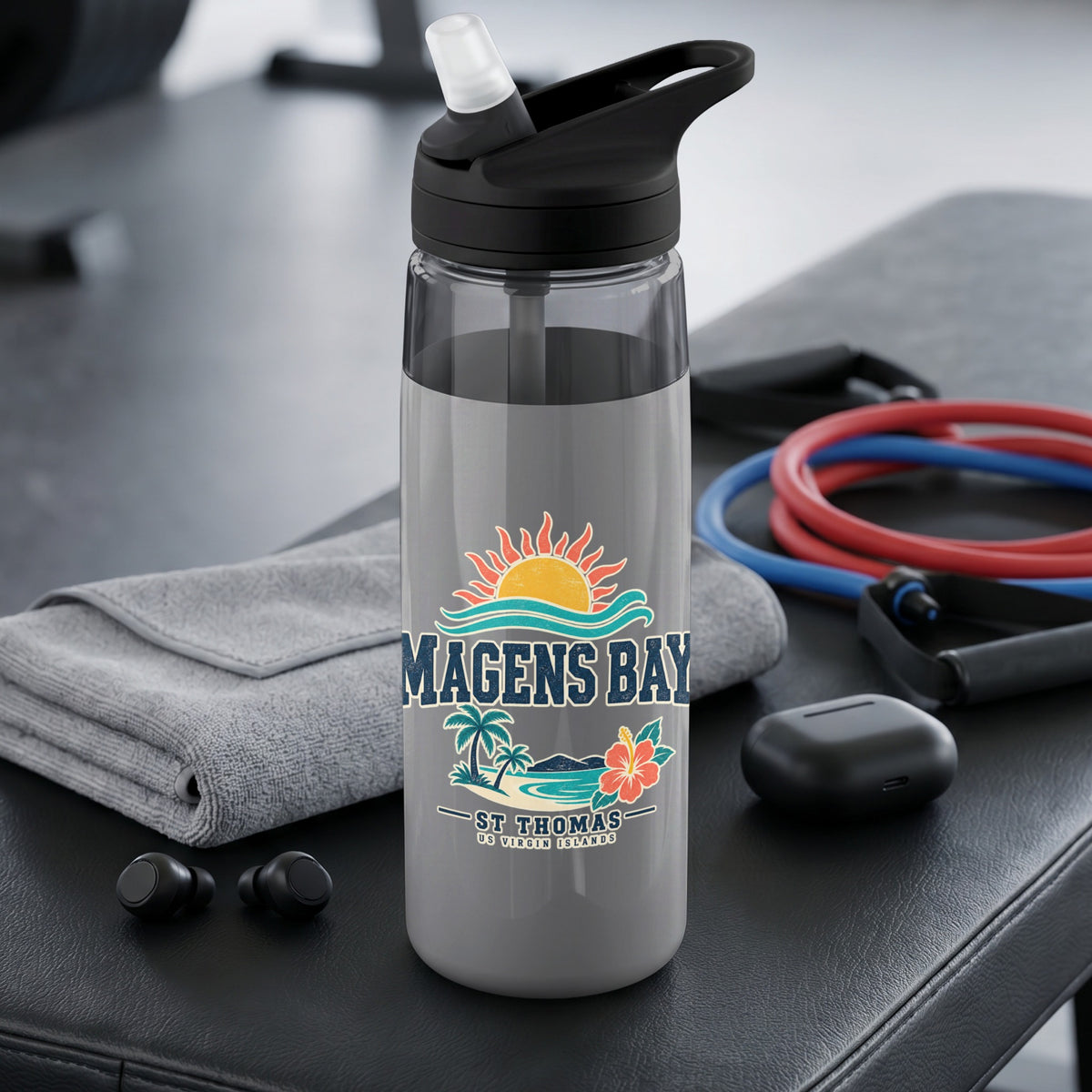 Water bottle with Magens Bay, St. Thomas graphic, gym equipment, and headphones.