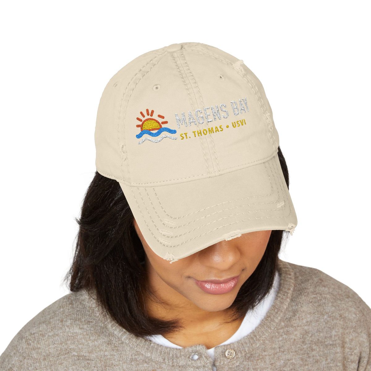 Tan distressed baseball cap with Magens Bay, St. Thomas, USVI embroidered on front.