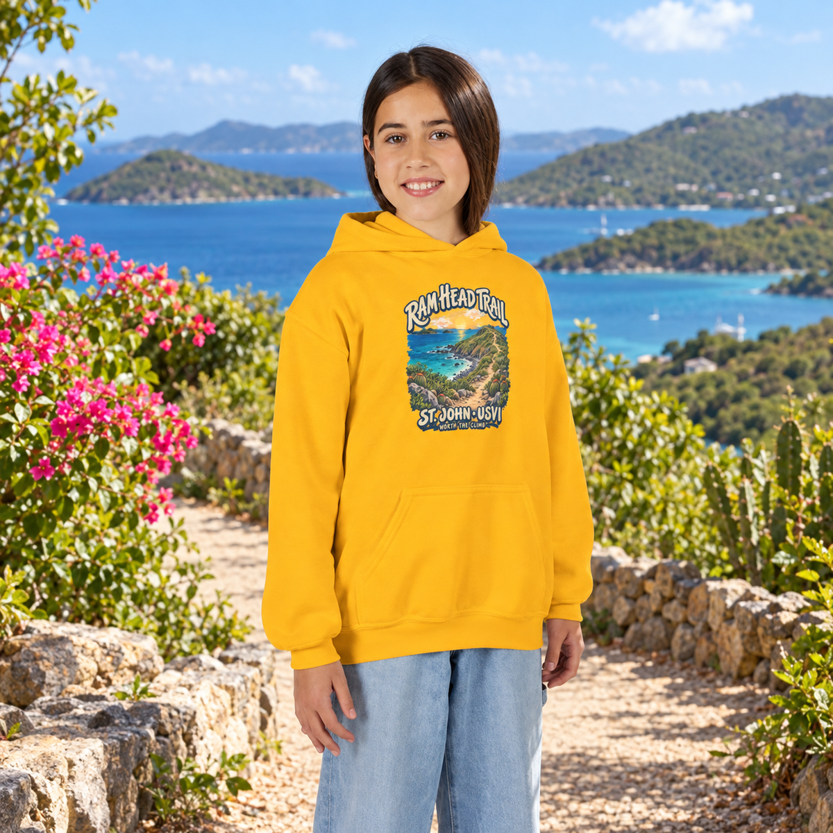 AI-generated lifestyle mockup of a child wearing a Gold Gildan 18500B youth hoodie with Ram Head Trail St John USVI artwork in a tropical coastal setting.