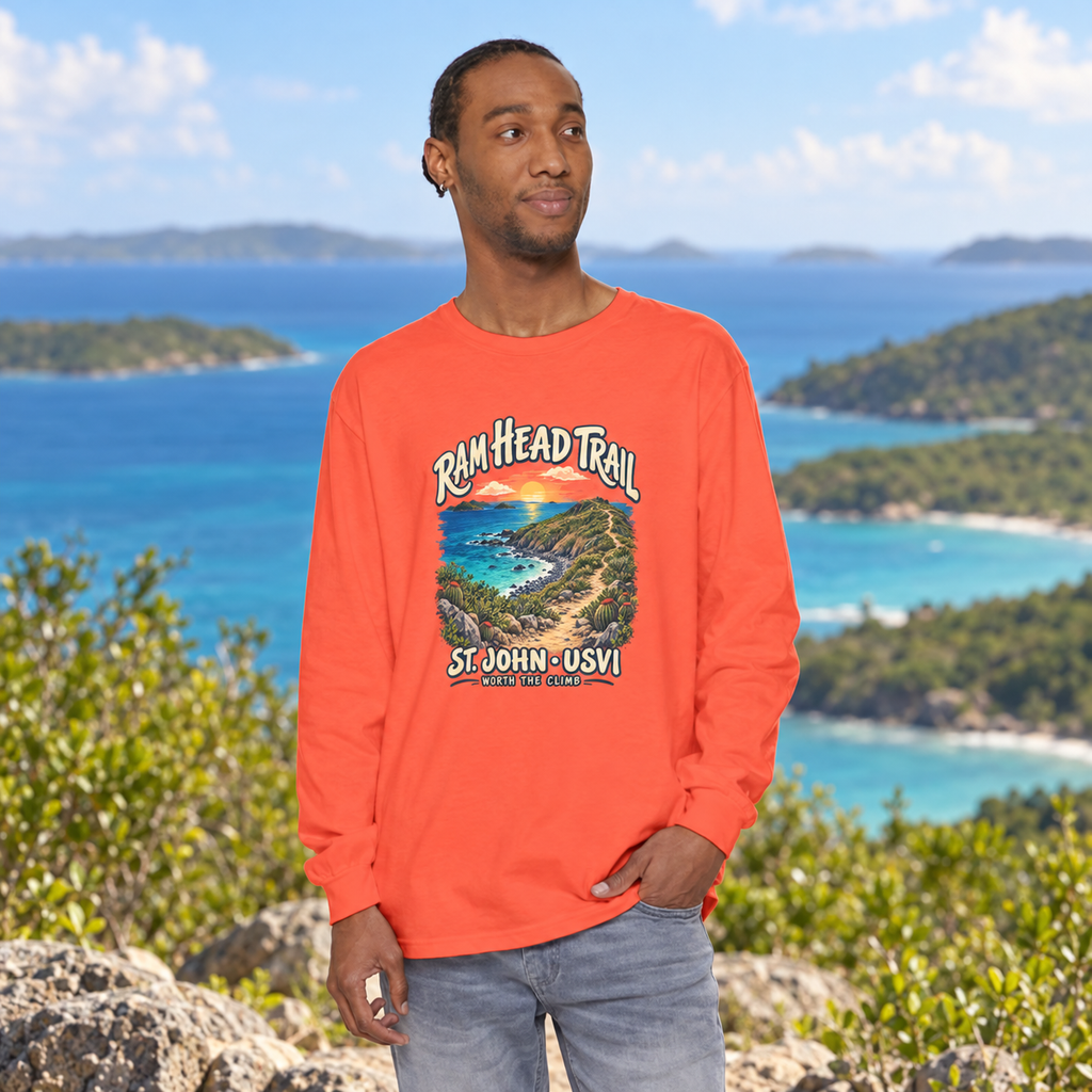 AI-generated lifestyle mockup of an adult model wearing a Bright Salmon Comfort Colors 6014 long-sleeve shirt with Ram Head Trail St. John USVI artwork beside a tropical coast.